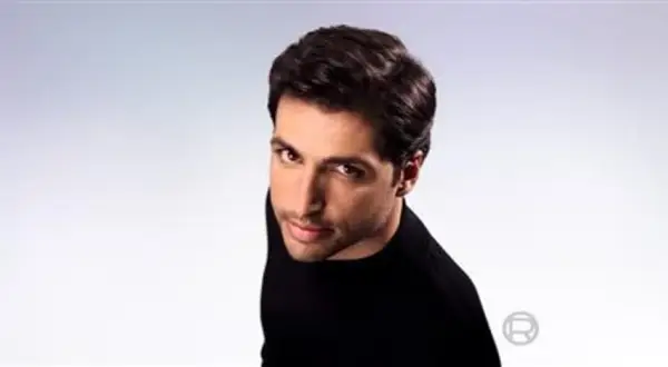 Hombre con pelo seco y oscuro, con mirada intensa, viste de negro.